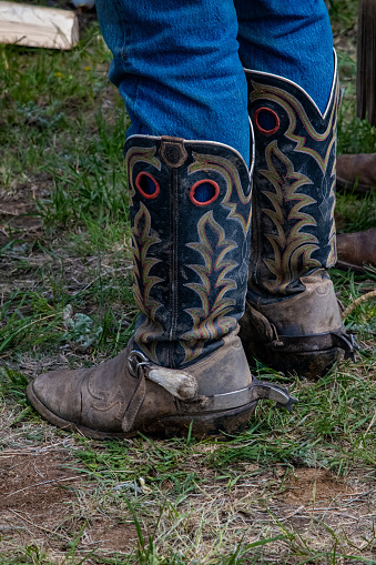 Well worn western boots and spurs