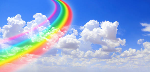 istock White clouds in the blue sky and colourful rainbow 1224659182