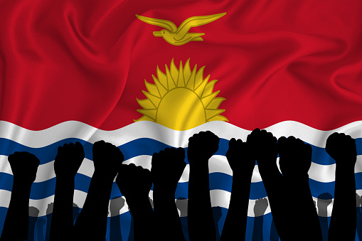 Silhouette of raised arms and clenched fists on the background of the flag of Kiribati. The concept of power,  conflict. With place for your text. 3D rendering