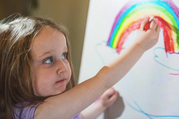 istock Girl Drawing on White Board Easel 1224659290