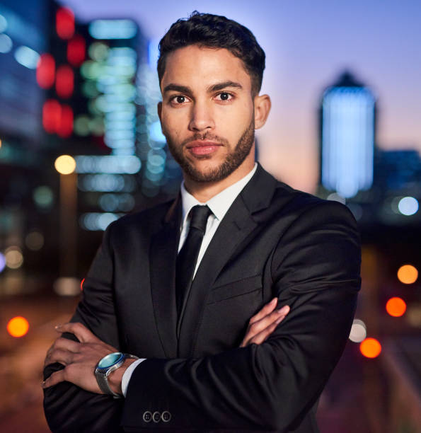 Portrait of a handsome young businessman posing outdoors in the city at night
