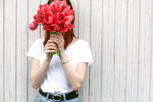 Woman holding bunch of fresh spring tulips.