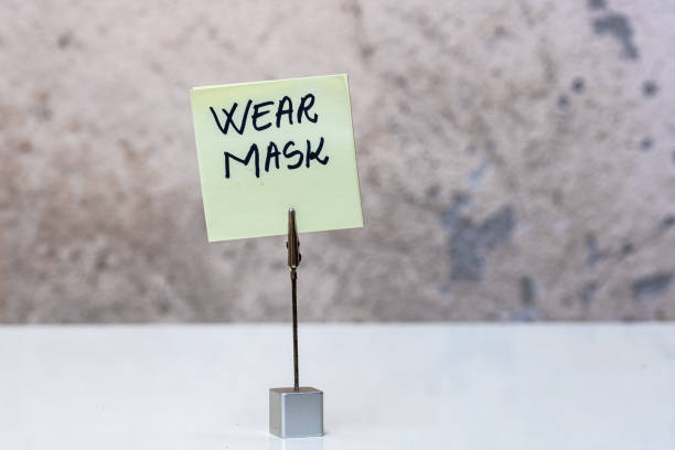 istock Wear mask handwriting text on memo post reminder isolated with copy space. 1224660443