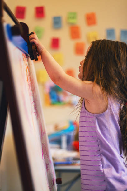 istock Girl Drawing on White Board Easel 1224660558