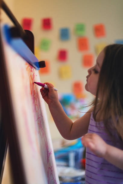 istock Girl Drawing on White Board Easel 1224660566