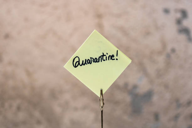 istock Quarantine handwriting text on memo post reminder isolated with copy space. 1224660573