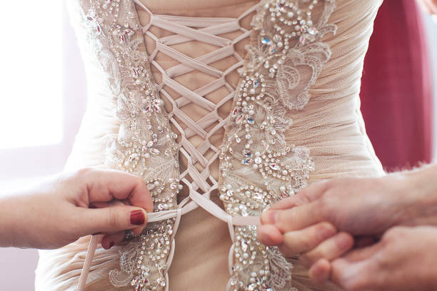 istock Hands Lacing Up Wedding Dress 1224660715