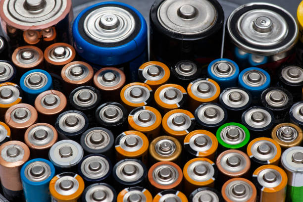 istock Used alkaline batteries AA size format of different brands lying in a rows 1224660740