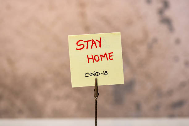 istock Stay home handwriting text on memo post reminder isolated with copy space. 1224660937
