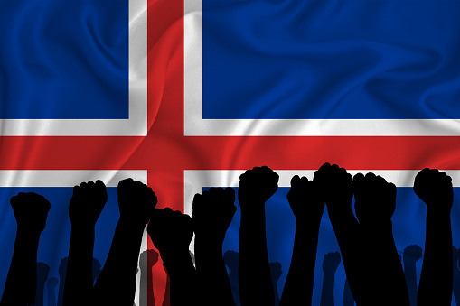 Silhouette of raised arms and clenched fists on the background of the flag of Iceland. The concept of power,  conflict. With place for your text. 3D rendering