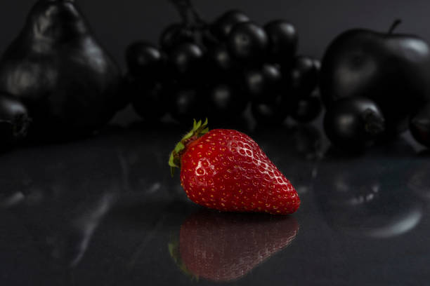 Black fruits on gray background