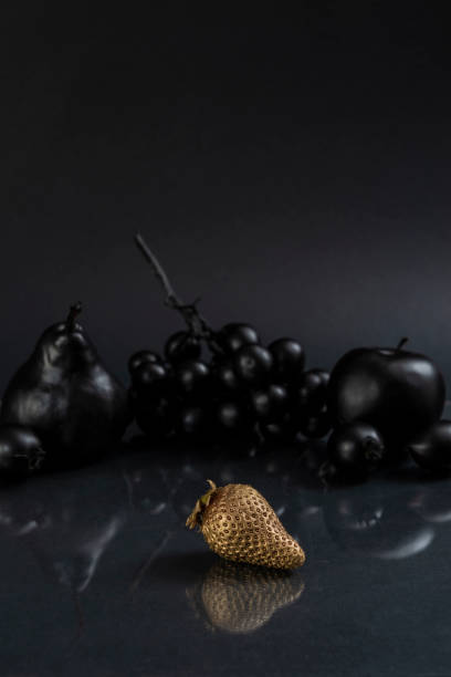 Black fruits on gray background