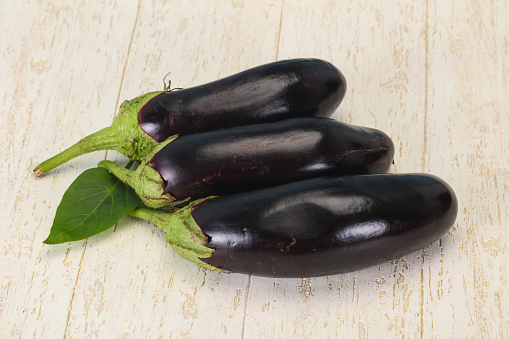 Few Ripe tasty Eggplant over wooden background
