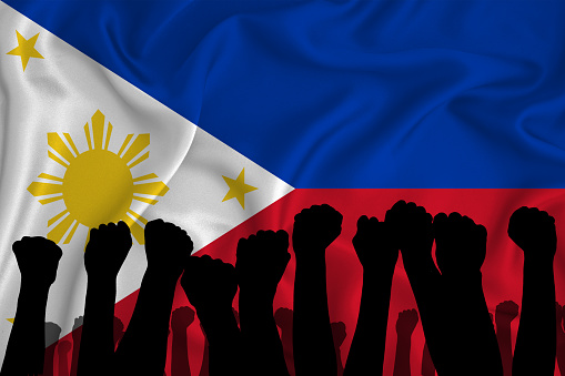 Silhouette of raised arms and clenched fists on the background of the flag of Philippines. The concept of power,  conflict. With place for your text. 3D rendering