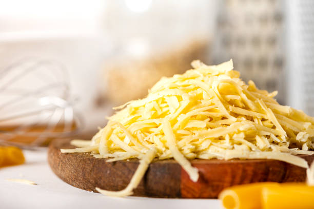 istock Pile of grated cheese on a cutting board close-up 1224663731