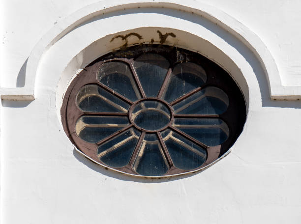 istock Old Round Window in a White Church 1224665201