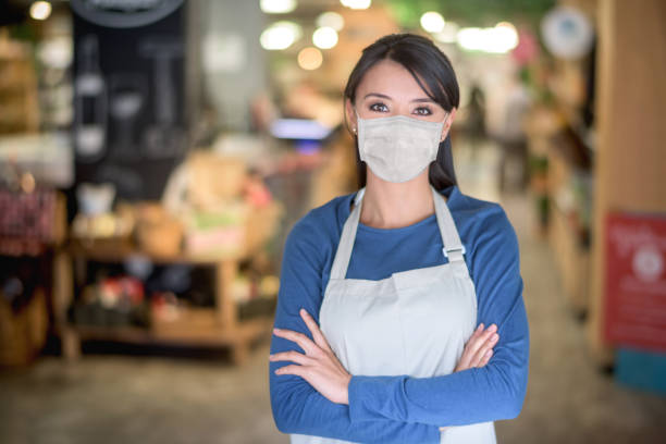 istock Business owner working at a supermarket wearing a facemask 1224667593