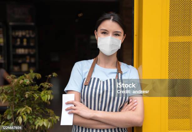 Business Owner Working At A Cafe Wearing A Facemask Stock Photo - Download Image Now