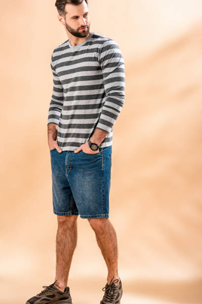 istock handsome bearded man posing in striped sweatshirt on beige 1224669649