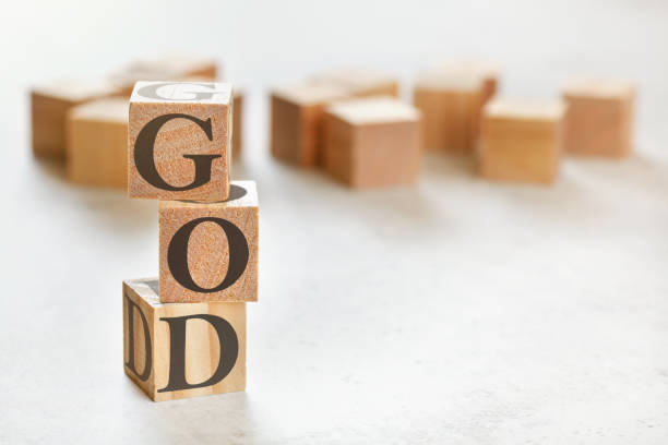 istock Three wooden cubes with word GOD, on white table, more in background, space for text in right down corner 1224671122