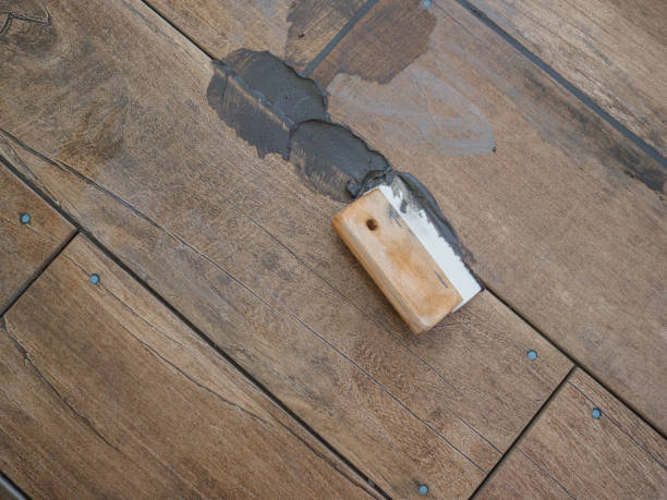 istock Grouting between ceramic tiles. Work tool spatula. Repair in the room 1224671276