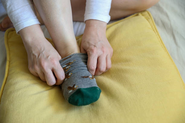 istock Beautiful patterned socks And a healthy woman's legs on a white bed 1224672708