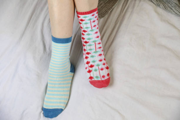 istock Women's legs in different beautiful socks. Colored socks on a background 1224672832