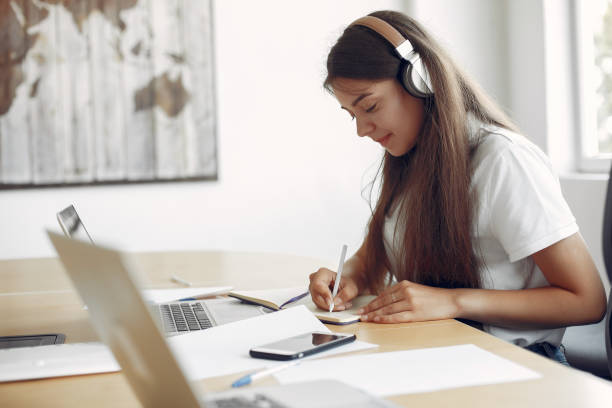 istock Young student sitting at the table and use the laptop 1224676246
