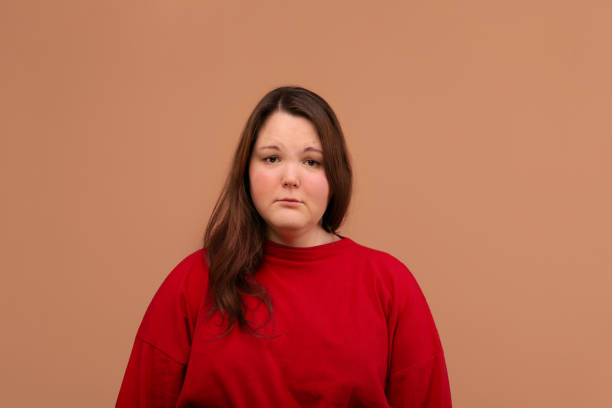 istock A sad expression of the young girl's face. Bright red jacket 1224676772