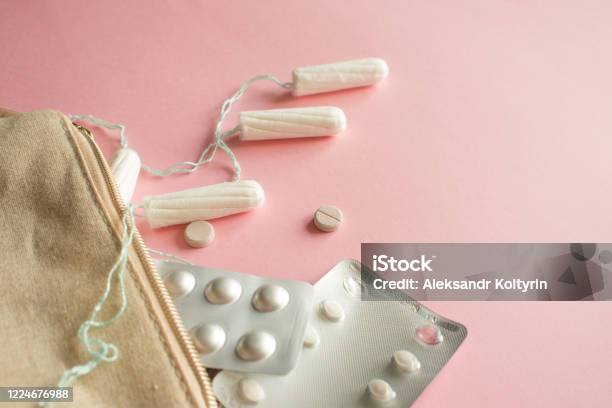 Cosmetic Bag Or Handbag With Tampons Contraceptives And Pain Pills Set In Case Of Menstruation Stock Photo - Download Image Now