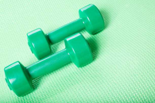 istock Green dumbbells with copy space. Fitness Accessories 1224678440
