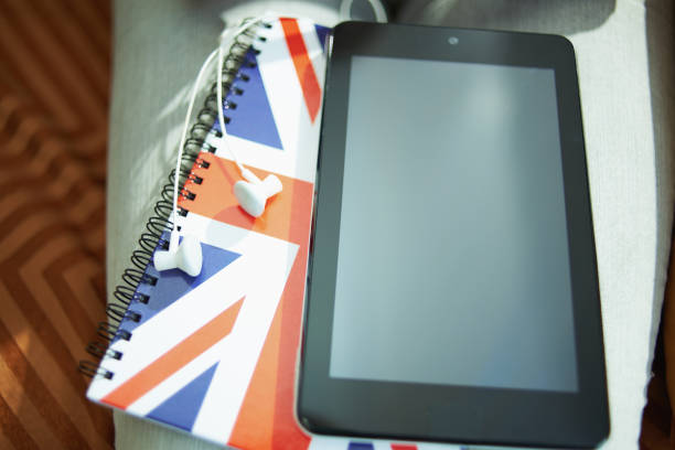 istock Closeup on tablet PC, headphones and UK flag notebook 1224681522