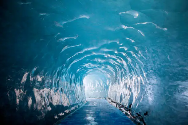 Photo of tunnel through ice glacier