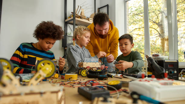 istock Way better than just engineering. Young technicians building a robot, working with a wiring kit together with a male teacher at a stem robotics class. Inventions and creativity for kids 1224684243