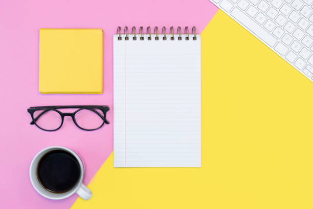 istock pink and yellow working place or online education concept. note pad. writing. coffee, keyboard, glasses. spring concept. 1224685136
