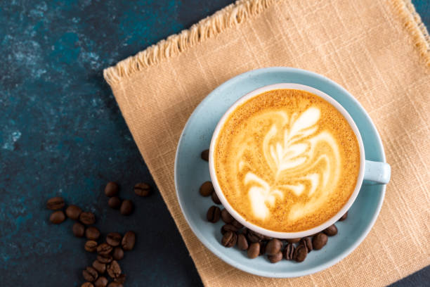 istock Flat lay Cappuccino coffee latte art in a cup , on blue background. 1224686334