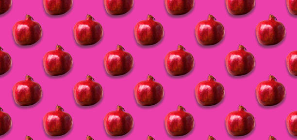 istock Seamless Pattern with ripe pomegranate on pink color background. 1224686345