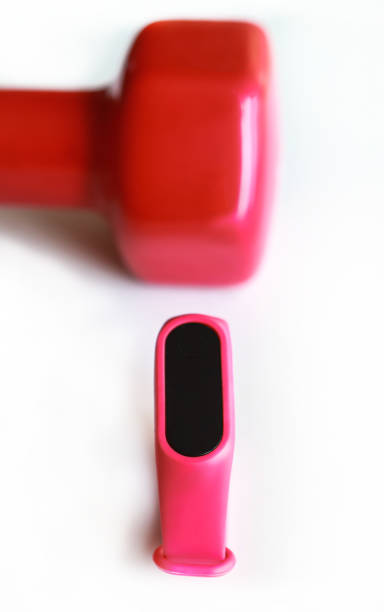 istock Red dumb bells with digital sport tracker isolated on white background. Selective focus 1224688522