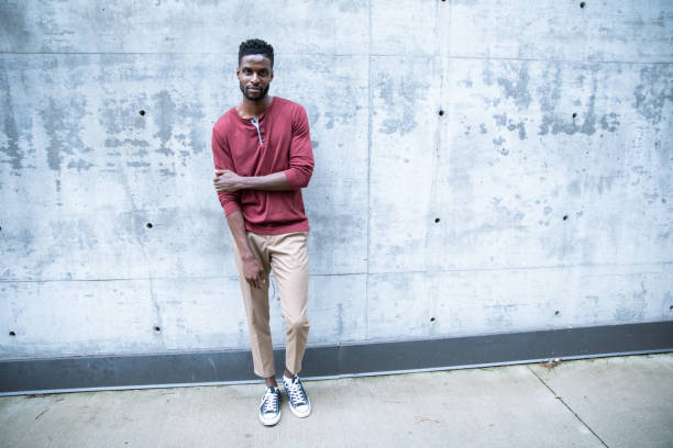 istock Cheerful Black Male Standing by a Concrete Wall 1224689449
