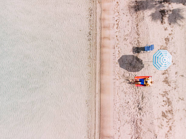 istock Aerial View Man Sunbathing on the Untouched Beach 1224692533
