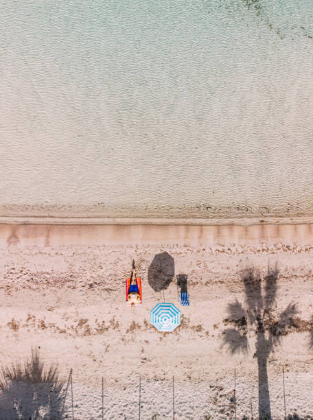 istock Aerial View Man Sunbathing on the Untouched Beach 1224692894