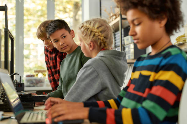 istock Simple Solutions. Curious kids are learning more about working principle of 3d printer at technology class 1224693983