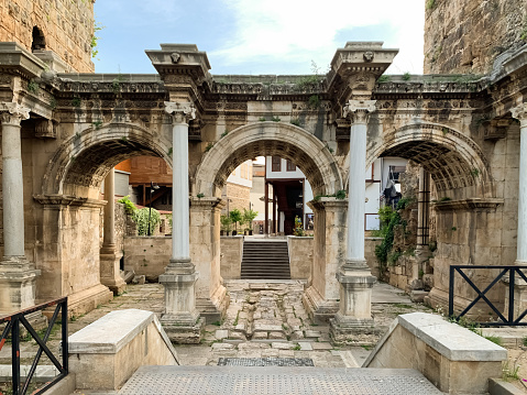 View of historical ancient monument Hadrian`s Gate Uckapilar in old city of Antalya Kaleici, Turkey. Horizontal stock image