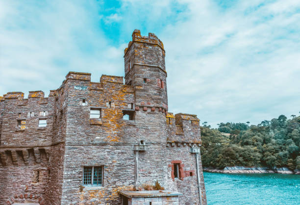 A female Asian tourist in her 40s is soaking up the Summer Irish sun along the coastline of Kinsale in Country Cork. She's enjoying the affluent neighborhood of Summer Cove.