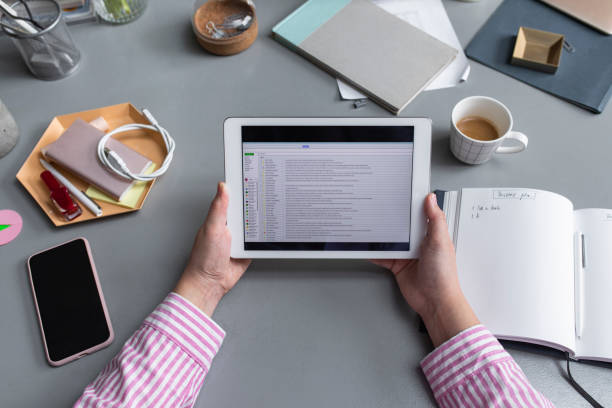 Unrecognizable Businesswoman Using a  Digital Tablet to Check E-Mails at her Office, a Close Up
