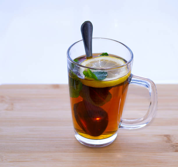 istock morning tea in a transparent glass with lemon and mint befor window 1224701851