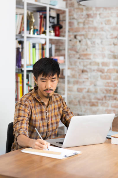 istock Diligent Asian College Student Studying at the Library 1224701947