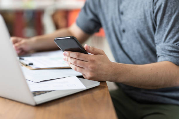 istock Hand of an Anonymous Businessman Using a Smartphone at the Office 1224701971