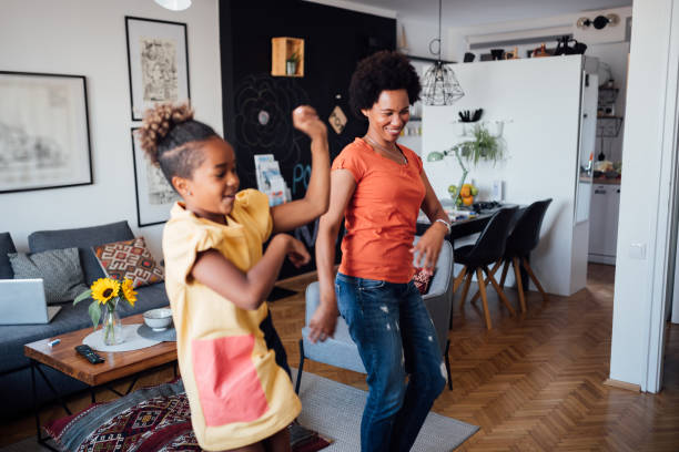 istock Mother and daughter dancing at home 1224702160