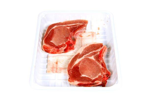 istock Raw Pork chops in a packing dish on a white background 1224703297
